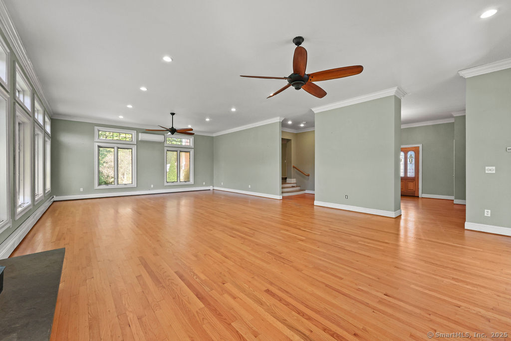 105 School Road Bolton, CT 06043 - Photo 14 of 39 a view of an empty room with wooden floor and a window