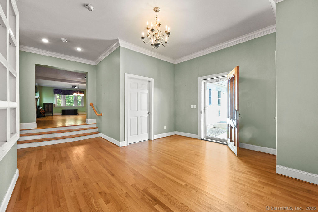 105 School Road Bolton, CT 06043 - Photo 15 of 39 a view of empty room with wooden floor and fan