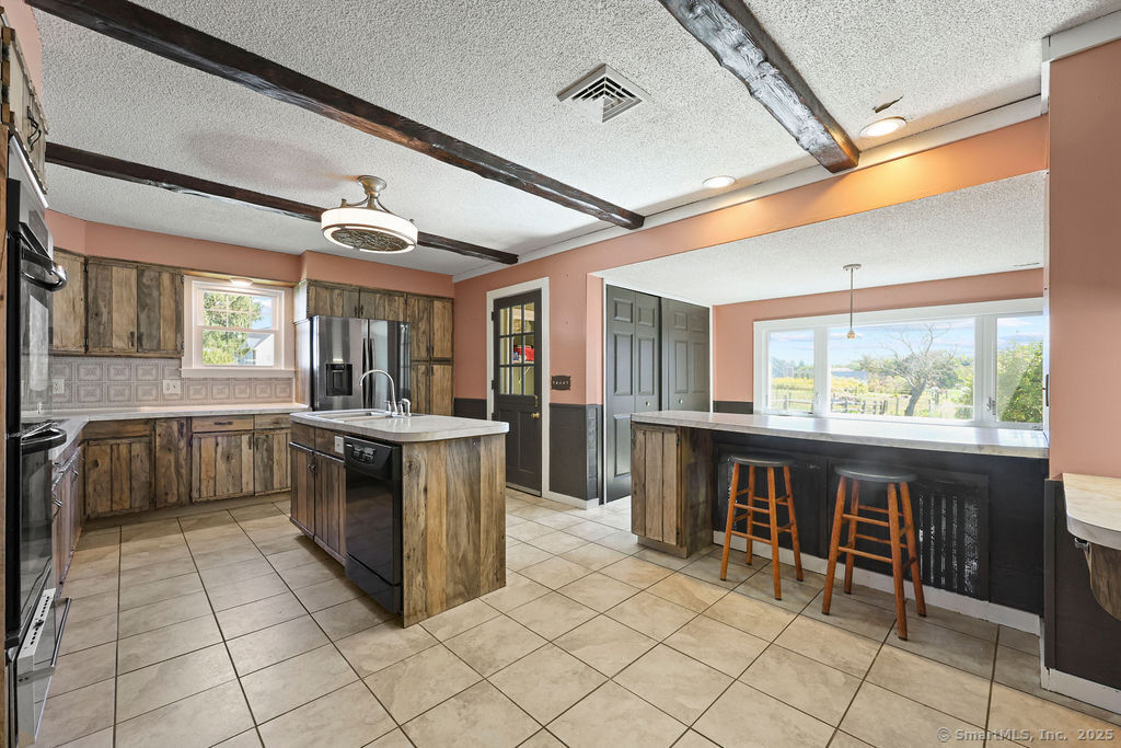 105 School Road Bolton, CT 06043 - Photo 19 of 39 a kitchen with stainless steel appliances granite countertop a stove and a refrigerator