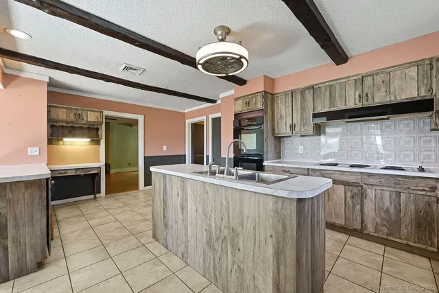 a kitchen with stainless steel appliances granite countertop a sink and cabinets