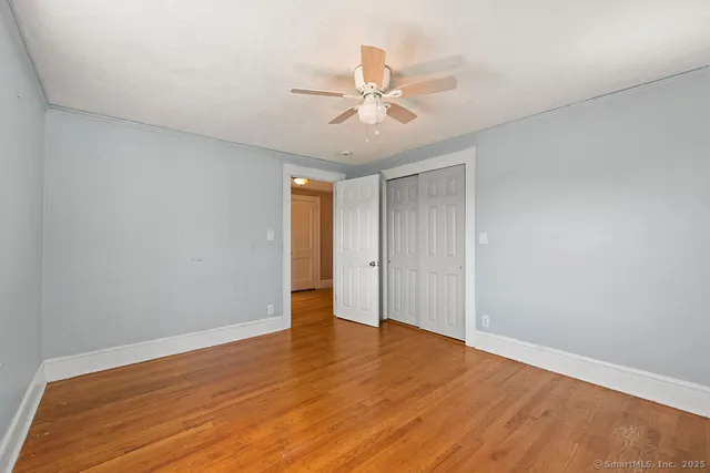 a view of an empty room and wooden floor