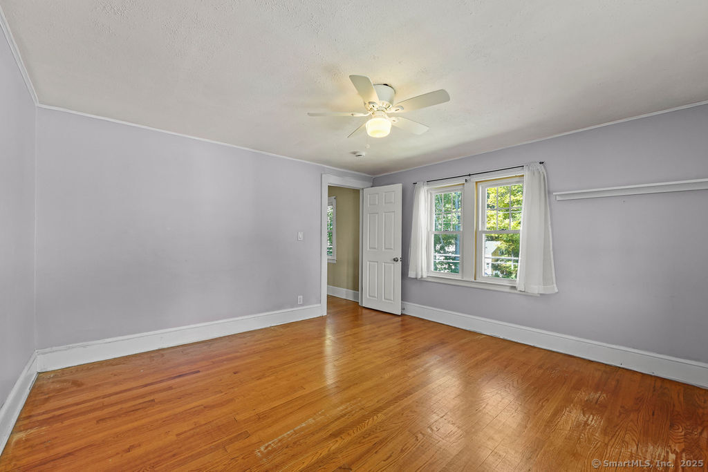 105 School Road Bolton, CT 06043 - Photo 24 of 39 a view of an empty room with a window and wooden floor