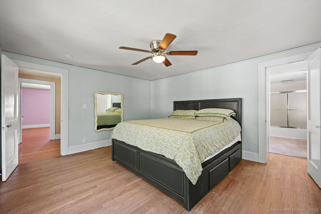 105 School Road Bolton, CT 06043 - Photo 25 of 39 a bedroom with a bed and a chandelier