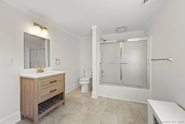 a bathroom with a toilet a sink and mirror