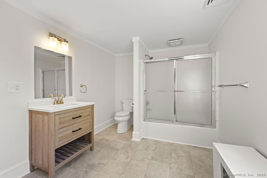 105 School Road Bolton, CT 06043 - Photo 26 of 39 a bathroom with a toilet a sink and mirror