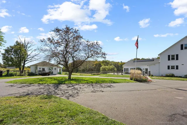 a view of a house with a yard and entertaining space