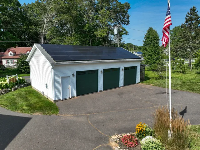 a view of a house with a yard and potted plants