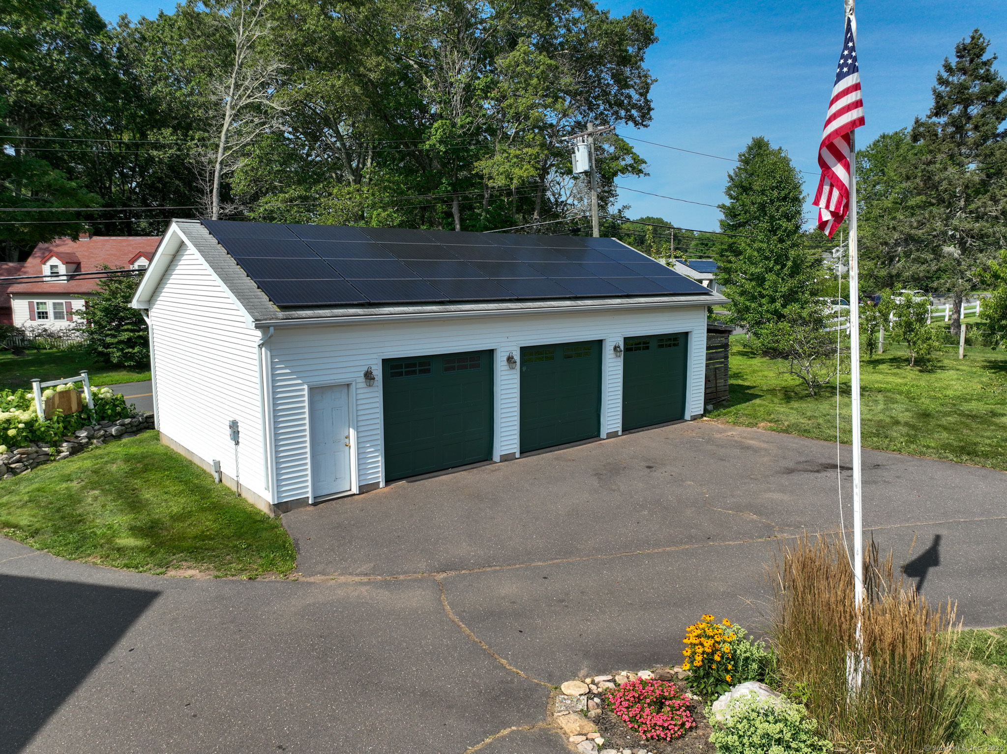 105 School Road Bolton, CT 06043 - Photo 34 of 39 a view of a house with a yard and potted plants