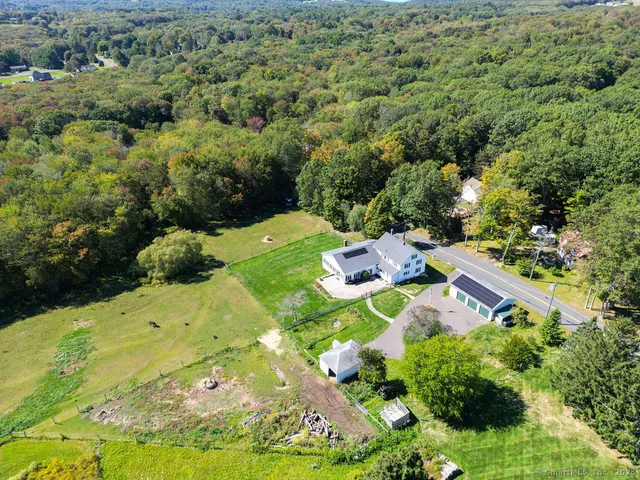an aerial view of a house with a yard and swimming pool