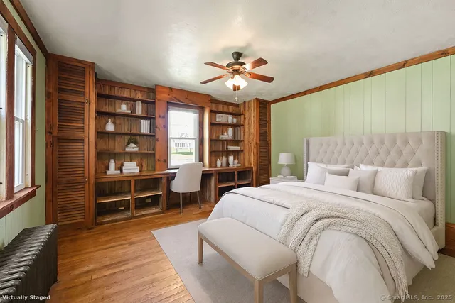 a spacious bedroom with a bed and a chandelier