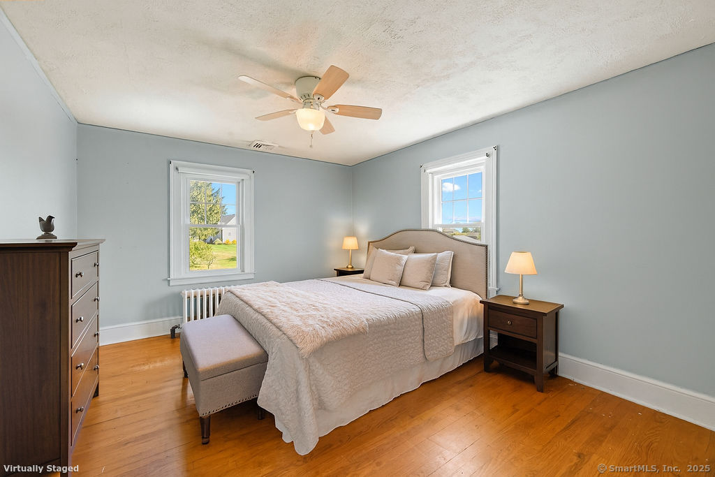 105 School Road Bolton, CT 06043 - Photo 8 of 39 a bedroom with a bed and a chandelier