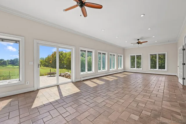 a view of an empty room with a window and balcony