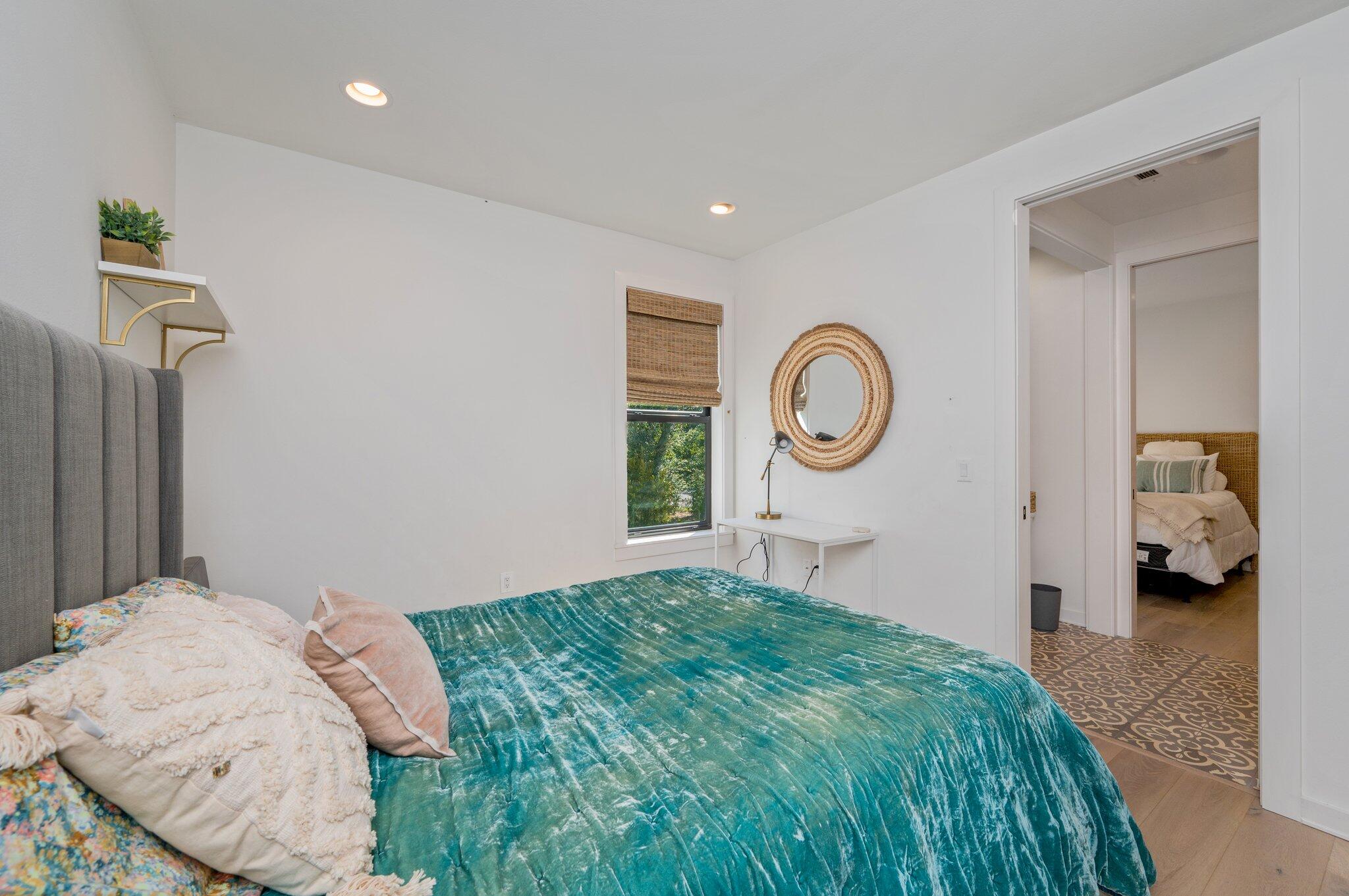 164 Bay Trace Santa Rosa Beach, FL 32459 - Photo 64 of 90 a bedroom with a bed and a chandelier