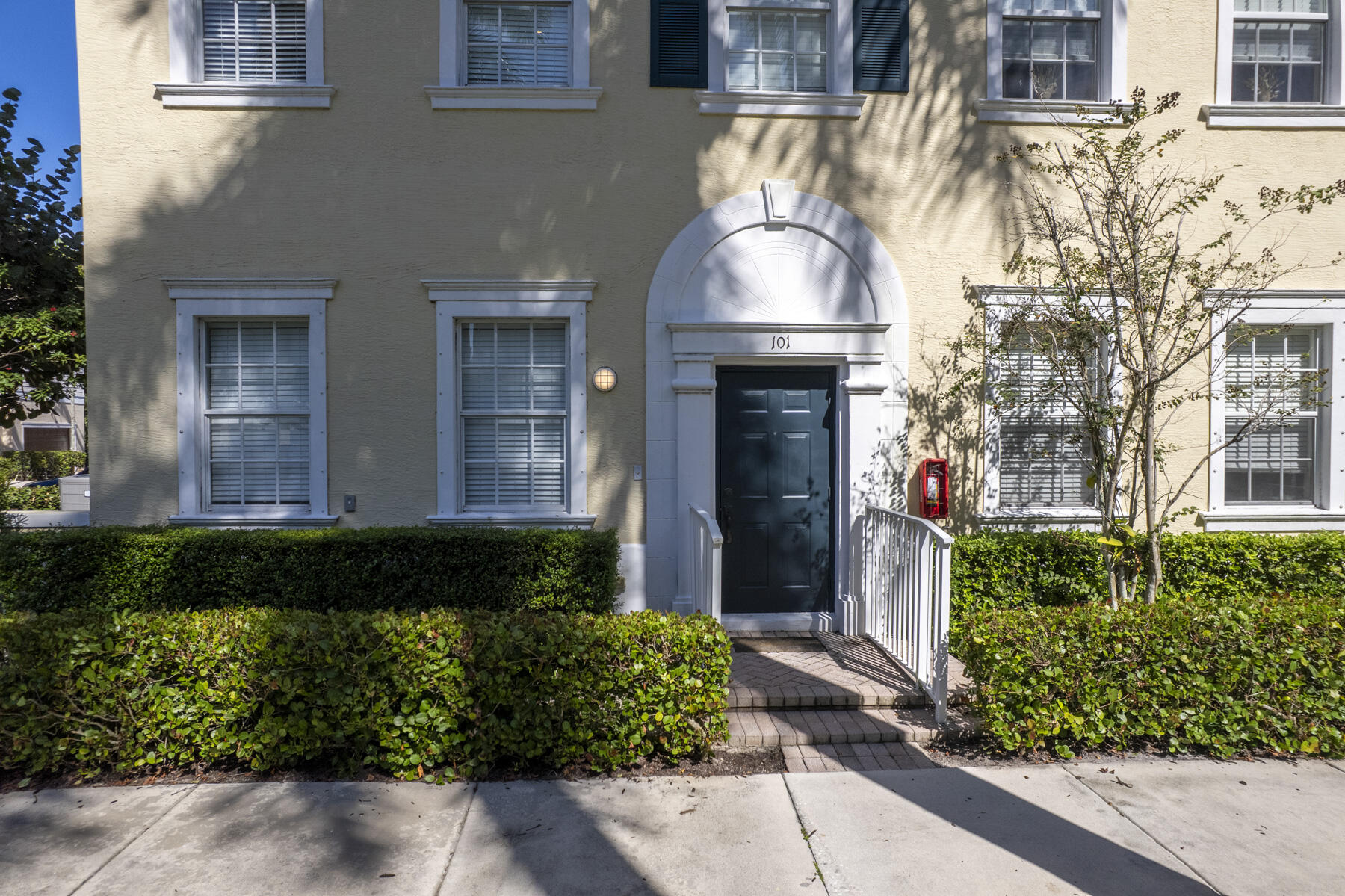 114 Locustberry Lane, Unit 101 Jupiter, FL 33458 - Photo 37 of 59 a front view of a house with a yard