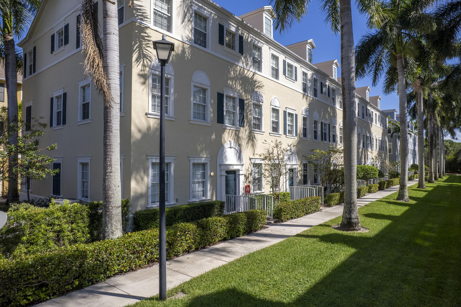 114 Locustberry Lane, Unit 101 Jupiter, FL 33458 - Photo 40 of 59 a view of a building with a yard