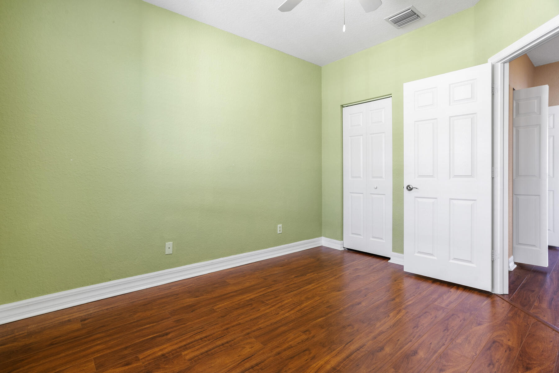 114 Locustberry Lane, Unit 101 Jupiter, FL 33458 - Photo 10 of 59 an empty room with wooden floor and closet