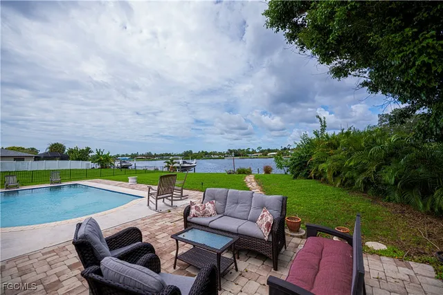 a living room with furniture a chandelier and a flat screen tv