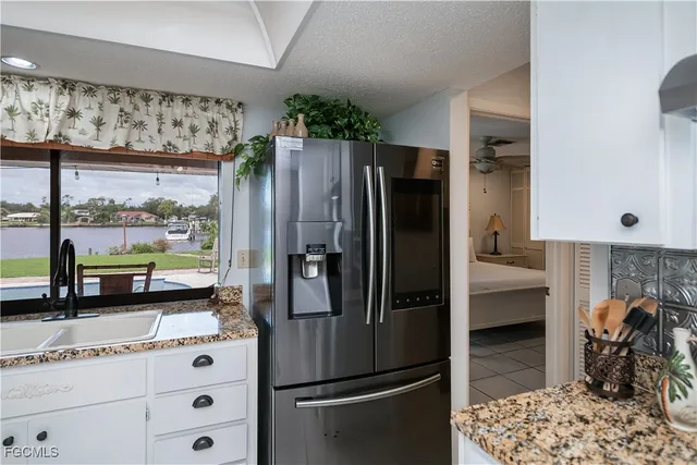 a kitchen with stainless steel appliances a stove a refrigerator and cabinets