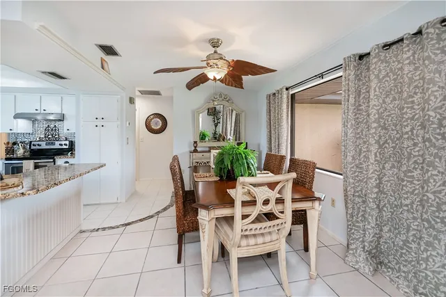 a dining room with furniture and window