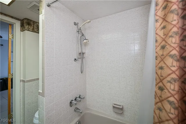 a bathroom with a sink toilet tub and shower