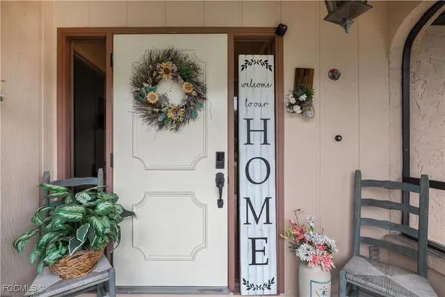a vase with flowers sitting on a table in front of a window