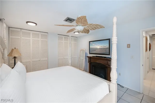 a bedroom with a large bed and a chandelier