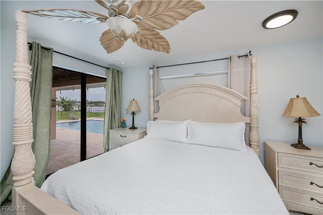 a bedroom with a bed and ceiling fan