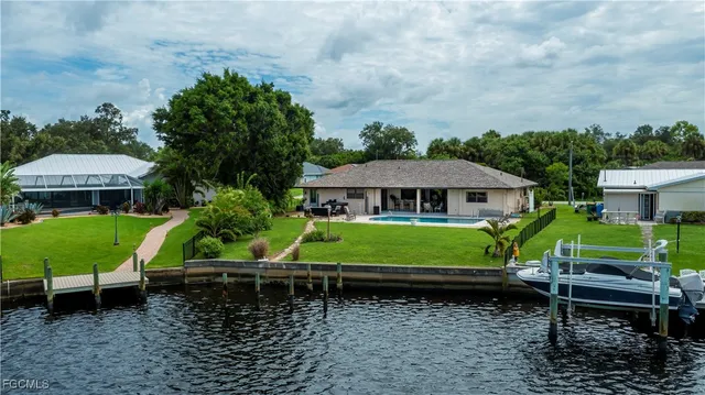 a green bench sitting in front of a house