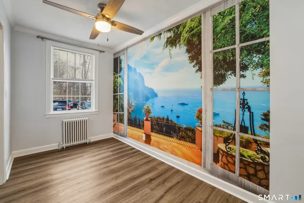 a view of an entryway with wooden floor