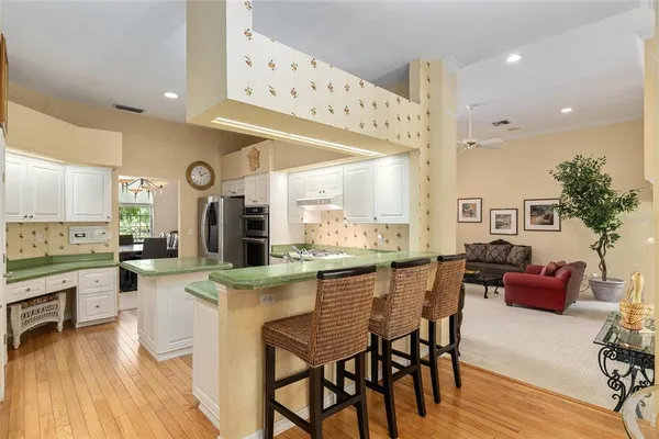 a kitchen with granite countertop a stove and cabinets