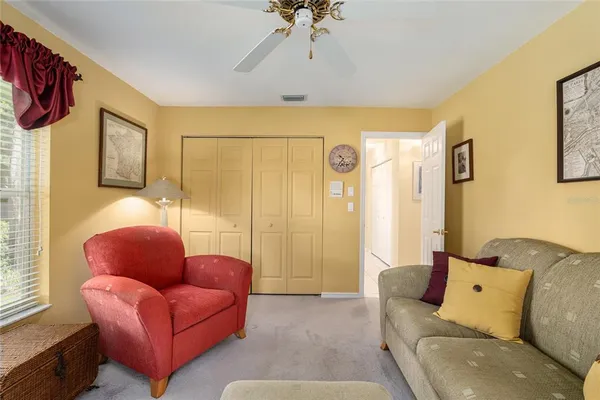a living room with furniture a fireplace and a floor to ceiling window