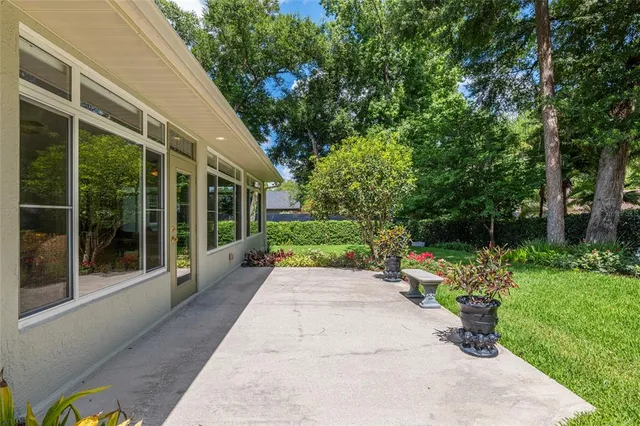 a view of an empty room with a window and cabinet