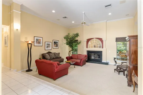 a living room with furniture a rug and a chandelier