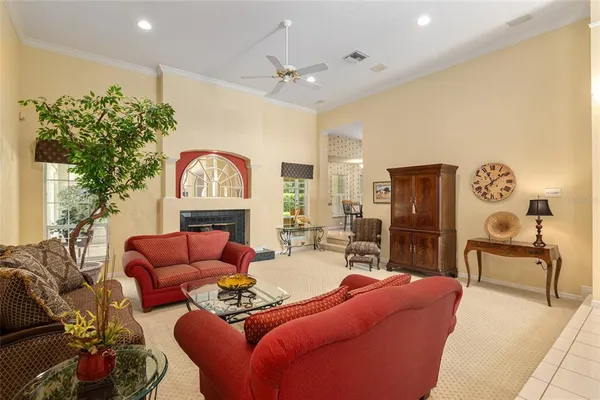 a living room with furniture a fireplace and a potted plant