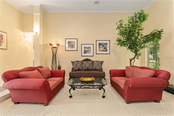 a living room with furniture ceiling fan and a rug
