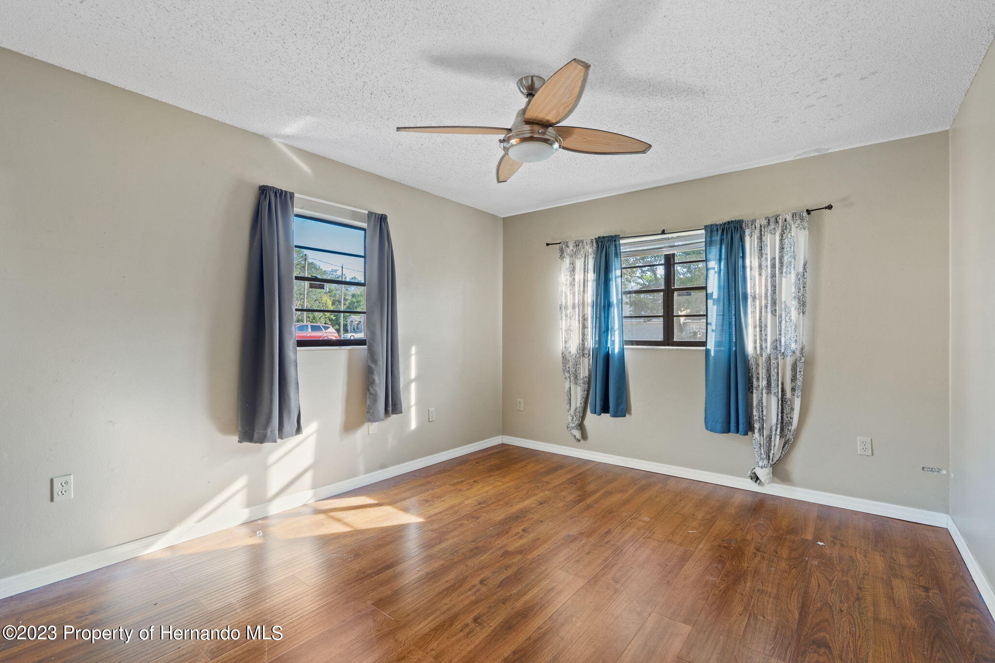 10479 Thornberry Drive Spring Hill, FL 34608 - Photo 12 of 44 a view of an empty room with wooden floor and a window