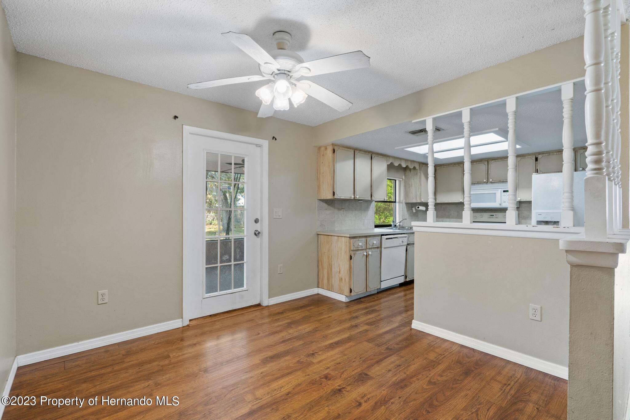 10479 Thornberry Drive Spring Hill, FL 34608 - Photo 13 of 44 a view of a kitchen with wooden floor and a ceiling fan