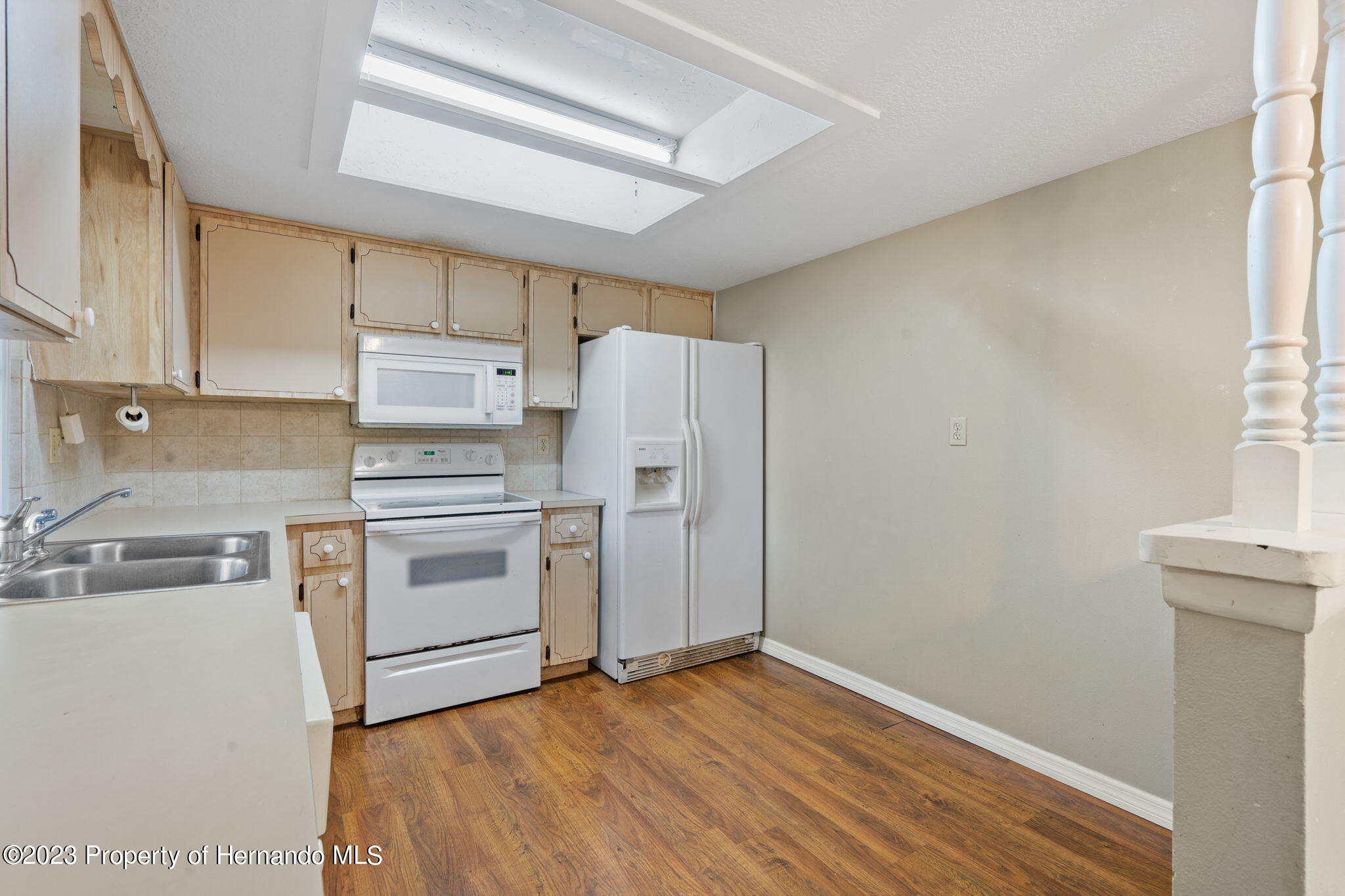10479 Thornberry Drive Spring Hill, FL 34608 - Photo 16 of 44 a kitchen with a stove a refrigerator and a sink