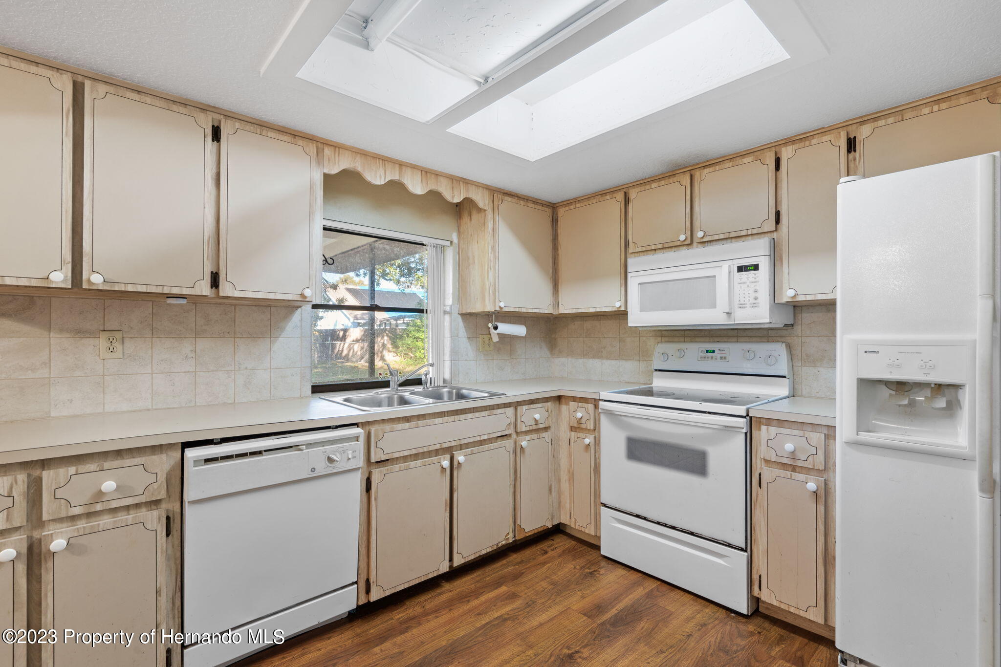 10479 Thornberry Drive Spring Hill, FL 34608 - Photo 17 of 44 a kitchen with cabinets appliances a sink and a window