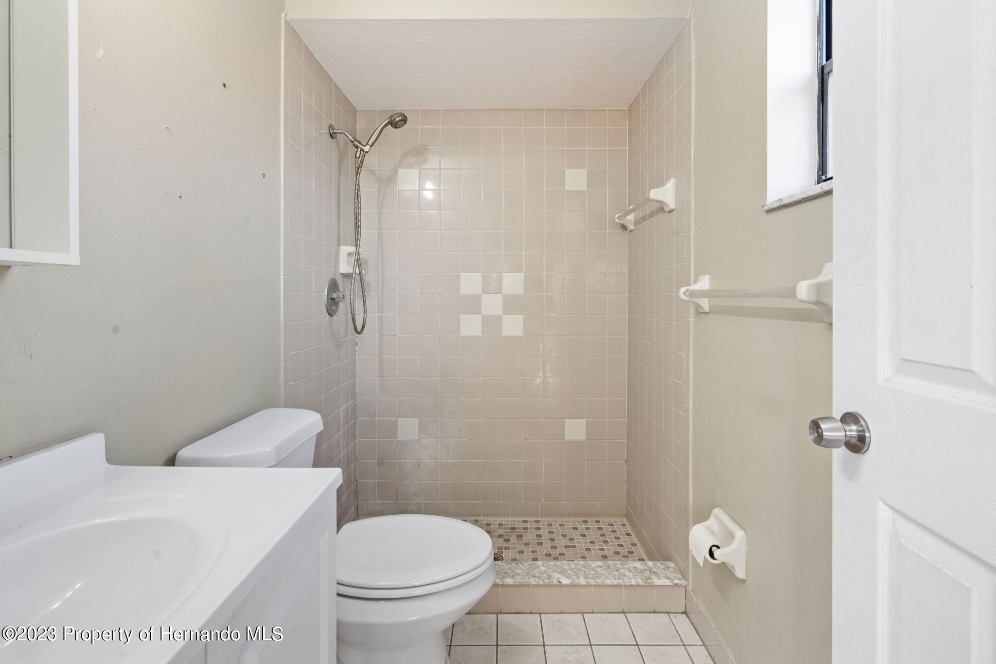 10479 Thornberry Drive Spring Hill, FL 34608 - Photo 20 of 44 a bathroom with a granite countertop shower a toilet and a sink