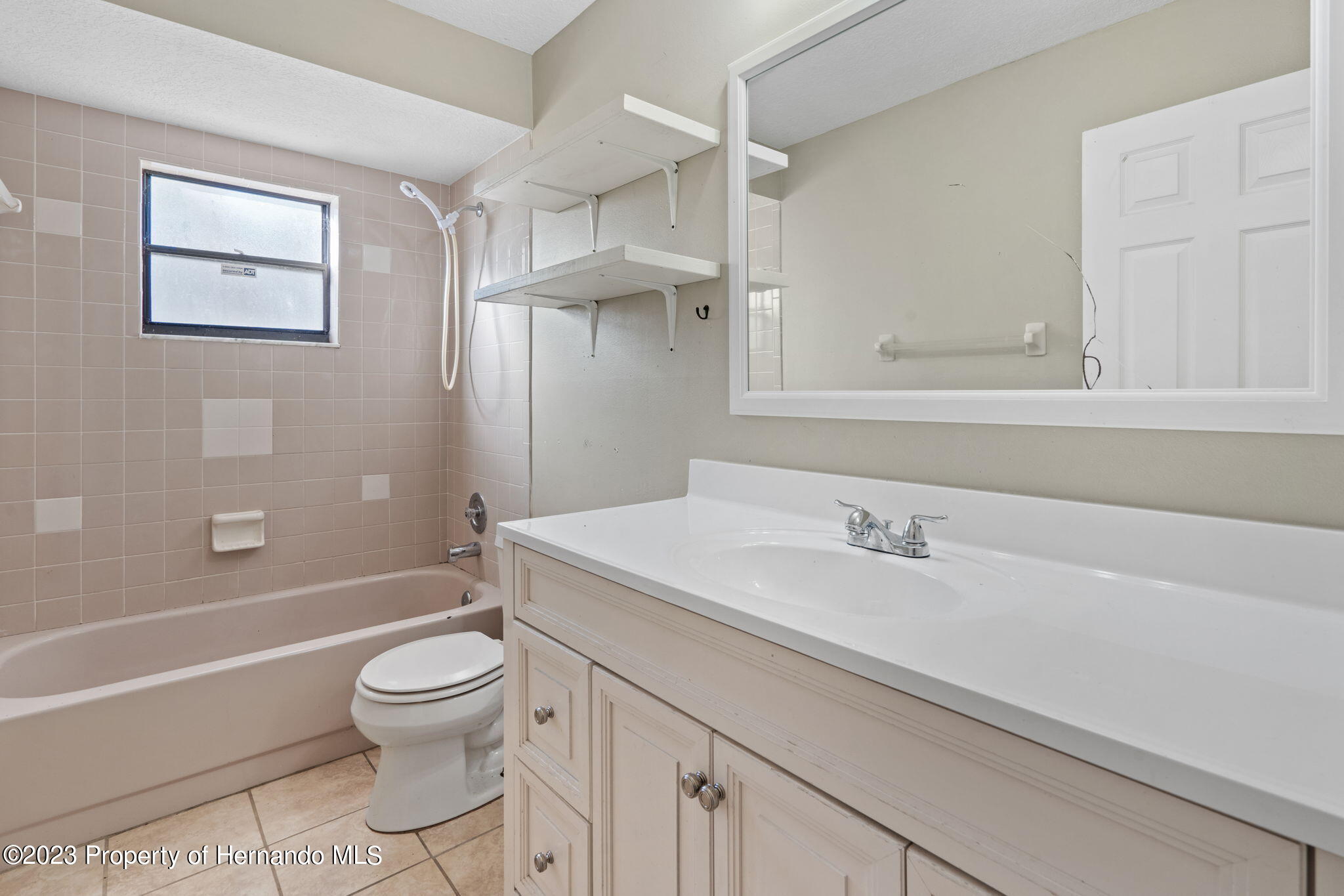 10479 Thornberry Drive Spring Hill, FL 34608 - Photo 26 of 44 a bathroom with a sink a toilet and shower