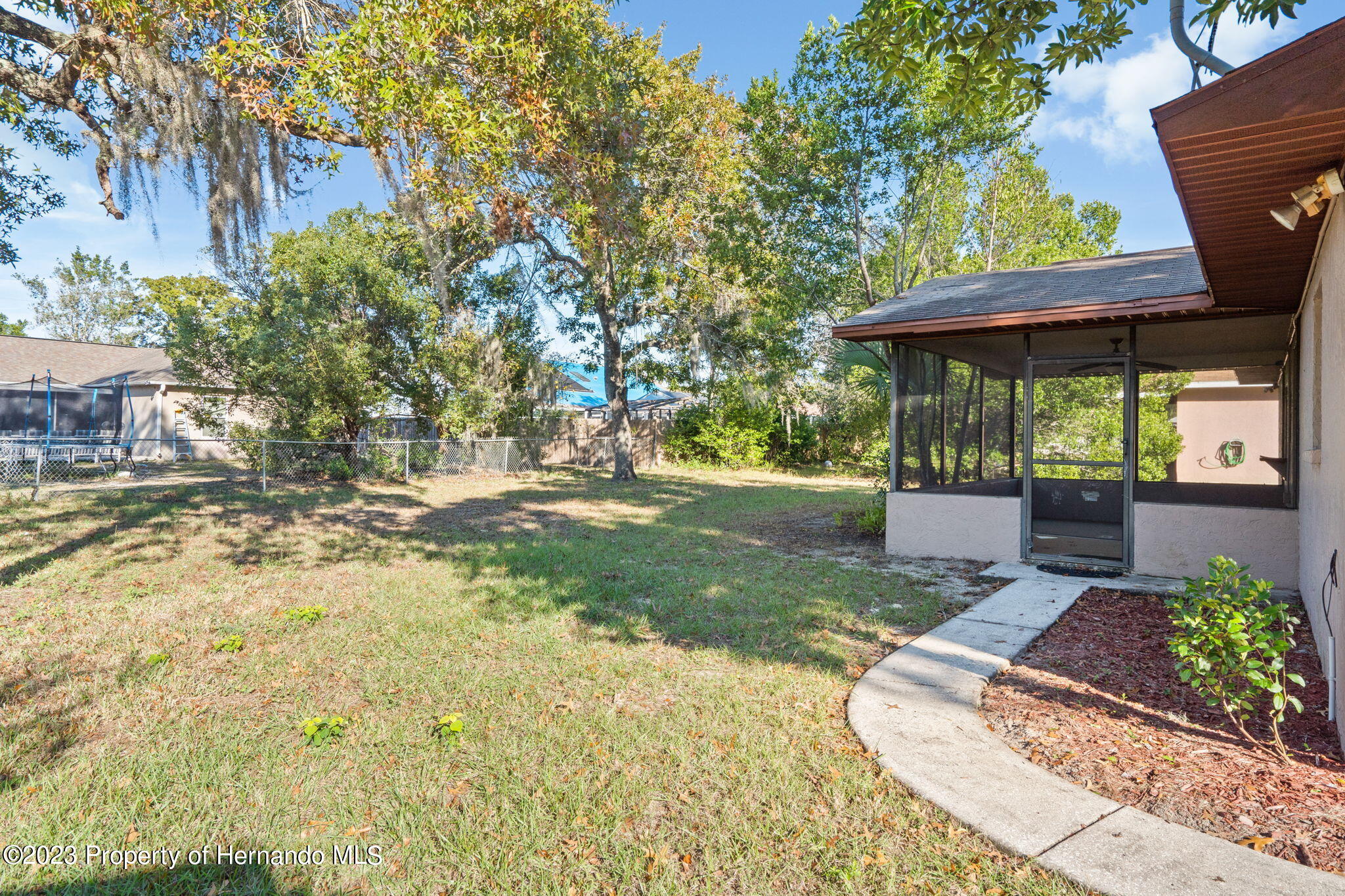 10479 Thornberry Drive Spring Hill, FL 34608 - Photo 29 of 44 a view of a patio with table and chairs under an umbrella