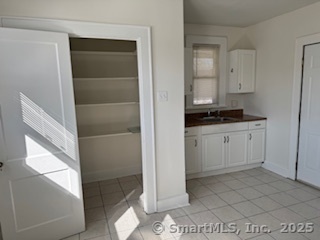 285 Clover Street, Unit 2 Stratford, CT 06614 - Photo 14 of 25 a bathroom with a sink a toilet and shower