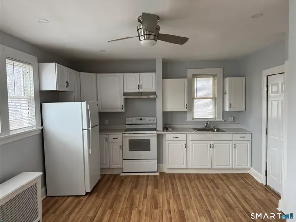 a kitchen with white cabinets and stainless steel appliances