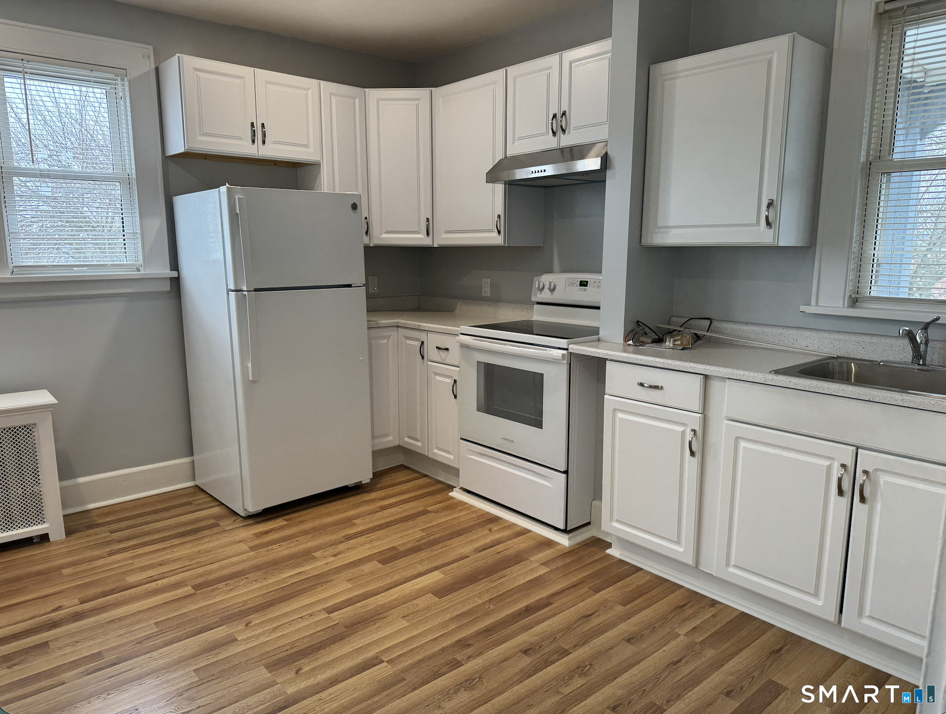 285 Clover Street, Unit 2 Stratford, CT 06614 - Photo 25 of 25 a kitchen with a refrigerator sink and cabinets