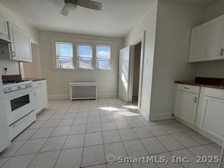 285 Clover Street, Unit 2 Stratford, CT 06614 - Photo 4 of 25 a kitchen with granite countertop a stove a sink and a refrigerator