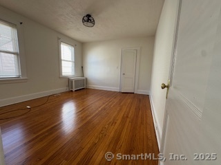 285 Clover Street, Unit 2 Stratford, CT 06614 - Photo 5 of 25 a view of a room with wooden floor and window