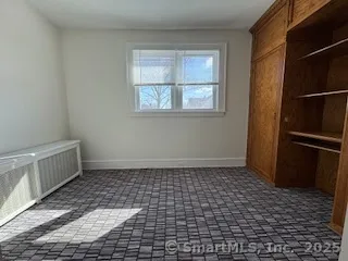 a bathroom with a sink a toilet a window and shower