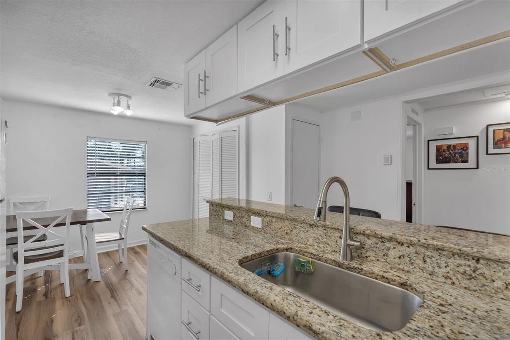 373 Eron Way, Unit 47 Winter Garden, FL 34787 - Photo 12 of 41 a kitchen with granite countertop a sink a counter top space and cabinets