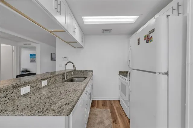 a kitchen with a sink and a refrigerator